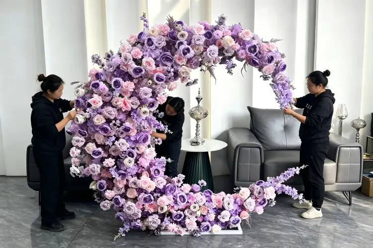 Two event staff assembling moon gate arch frame at wedding venue in 10 minutes