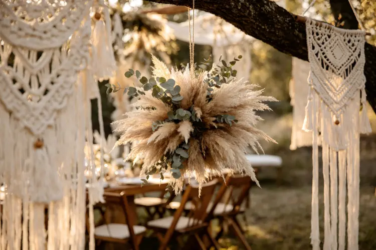 Dried pampas grass and preserved eucalyptus flower ball at bohemian outdoor wedding table